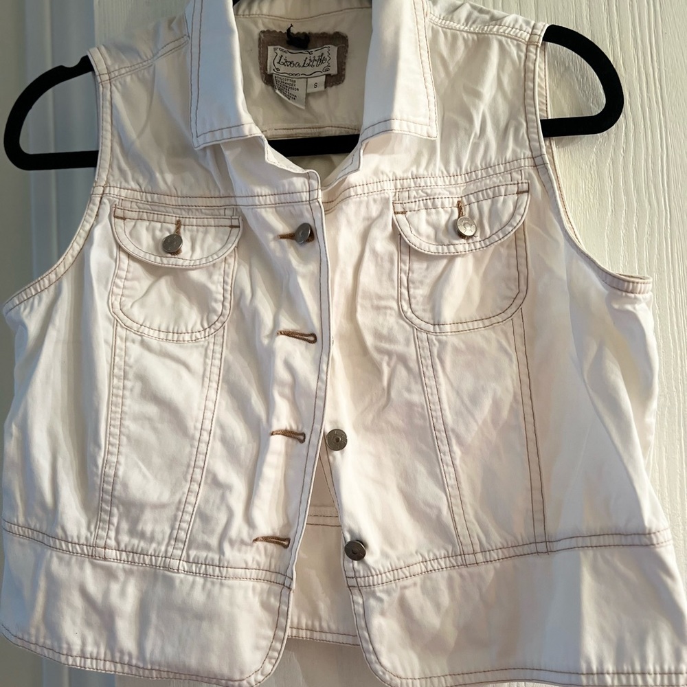 White sleeveless top which will look great with jeans.